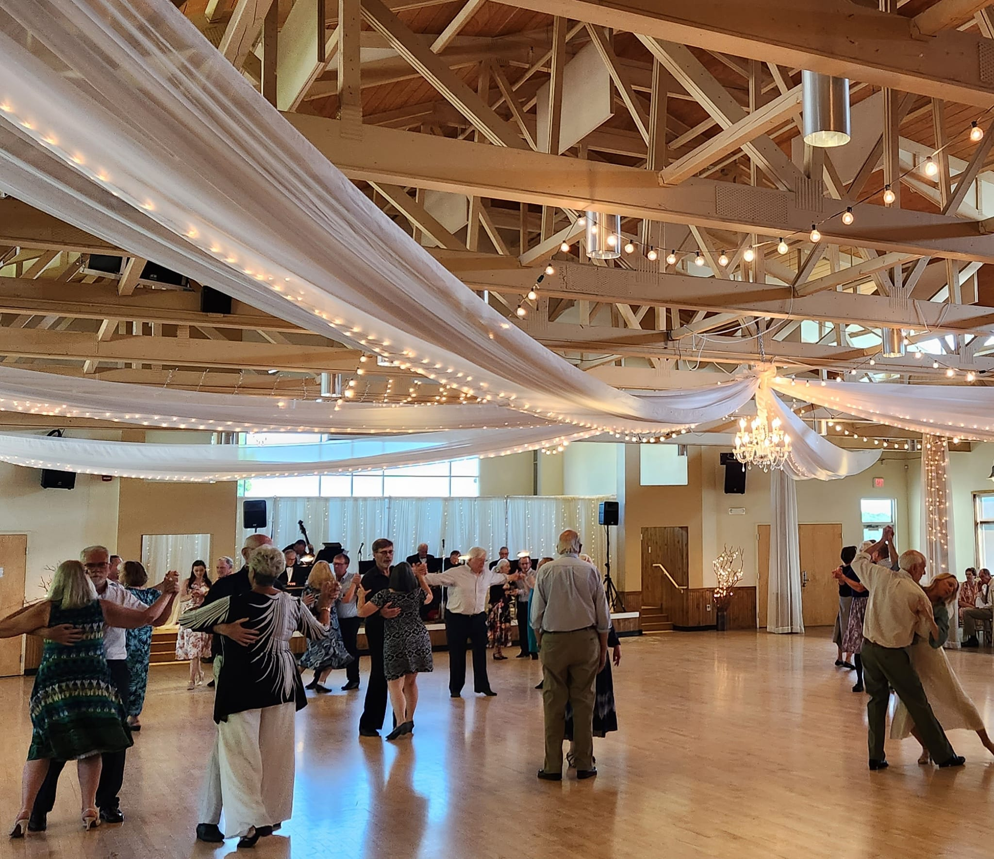Dancers at Lakeside Ballroom dance floor beneath chandelier